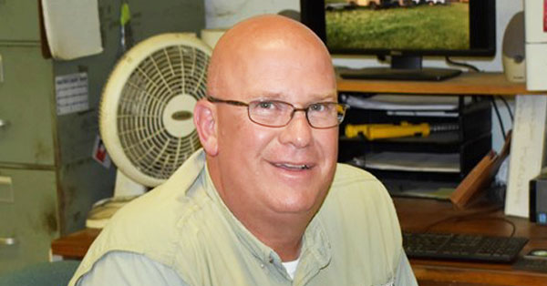 Tim Barr, vocational teacher who wore many hats, sits in his office.