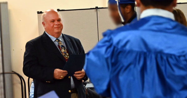 Dennis Smith with youth at graduation.