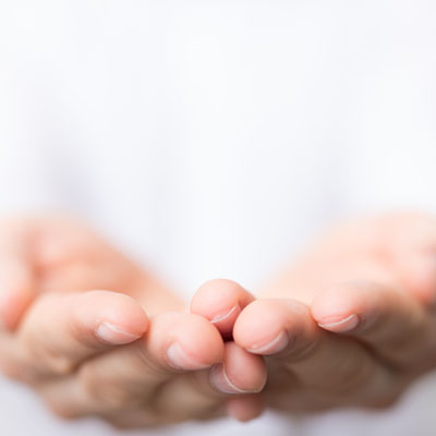 A close up image of a pair of hands reaching out.