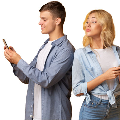 A girl looking over a boy's shoulder to catch a glimpse of his phone.