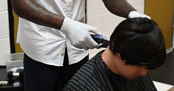 Featured image of youth getting a haircut at Mart.