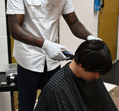 Mart youth getting a haircut by barber Mitch Babers.