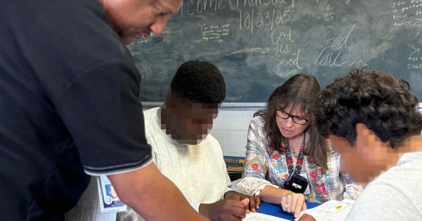 Featured image of teachers helping youth.
