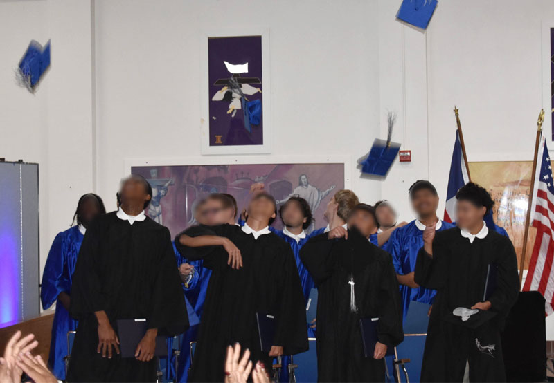 Giddings graduates tossing their caps in the air.