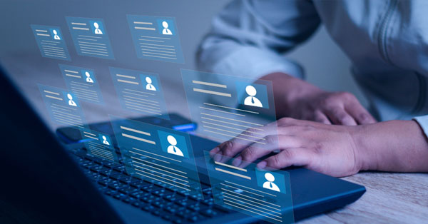 Employee entering data at a laptop.