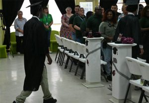 Youth start filing in at Mart graduation ceremony.
