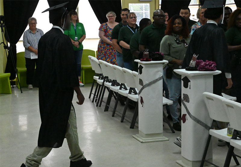 Youth start filing in at Mart graduation ceremony.