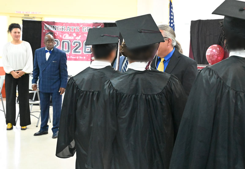 Graduates line up to receive congratulations.